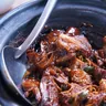 Pot of slow-cooked meat in sauce (illustrative photo)