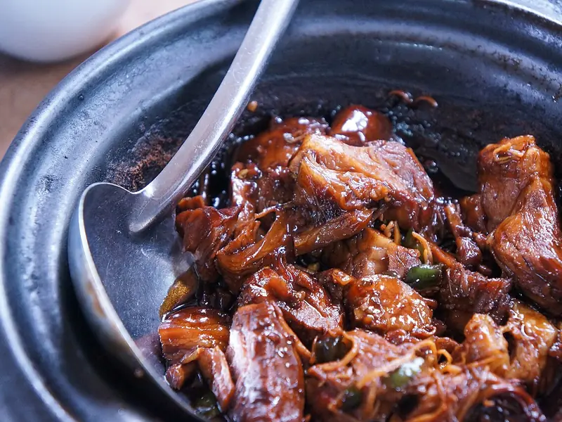 Pot of slow-cooked meat in sauce (illustrative photo)